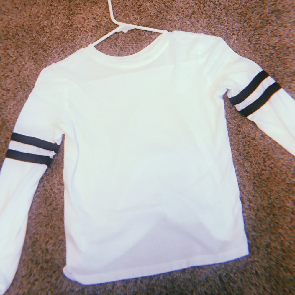 A white long sleeved kids shirt.